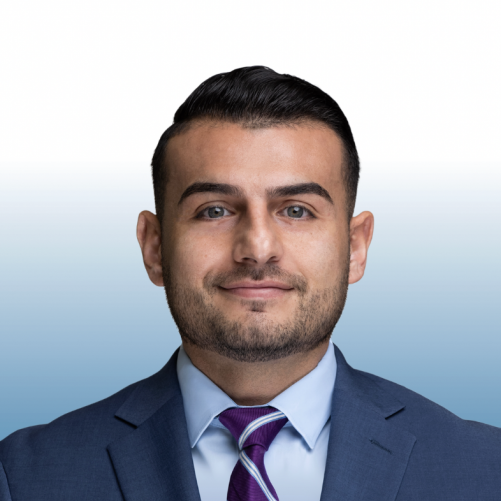 Professional headshot of an Equity team member in a suit and purple striped tie