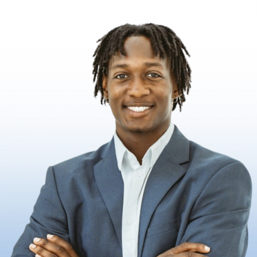 Professional headshot of an Equity team member in a navy blazer with arms crossed, smiling.