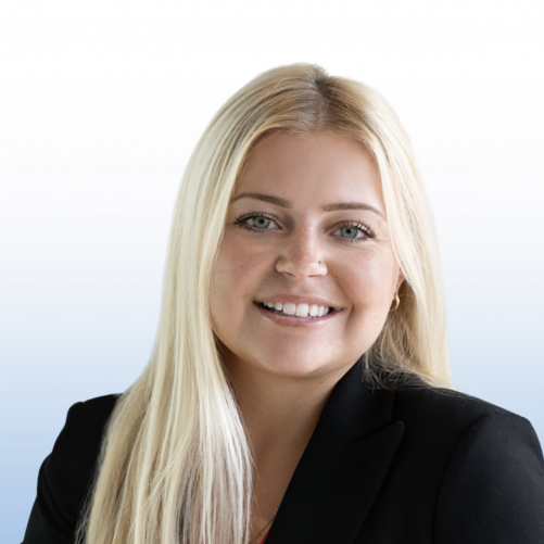 Smiling female Equity commercial real estate professional in black blazer, studio headshot