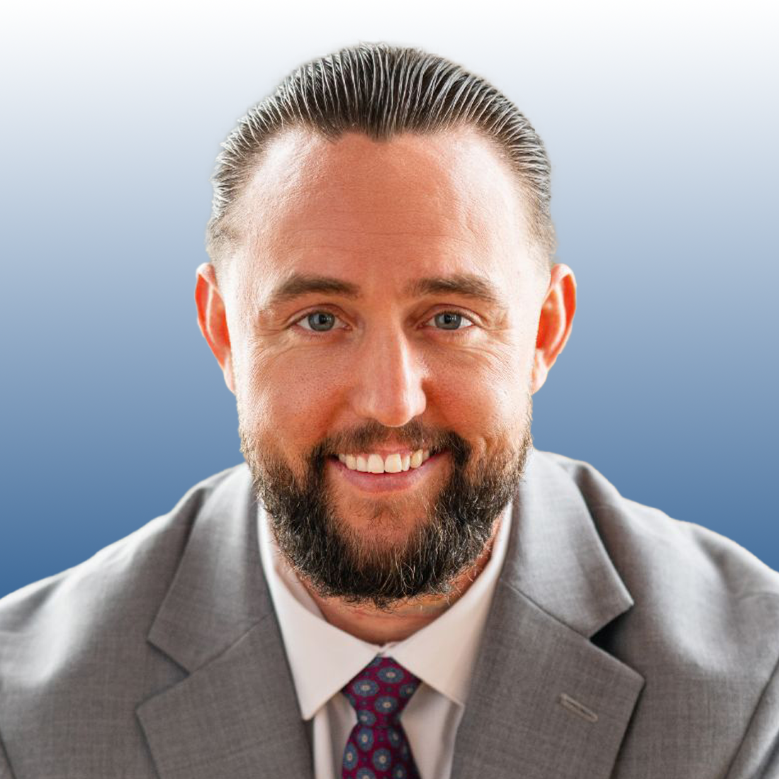 Michael Taylor, commercial real estate professional at Equity, smiling in a gray suit with a patterned tie
